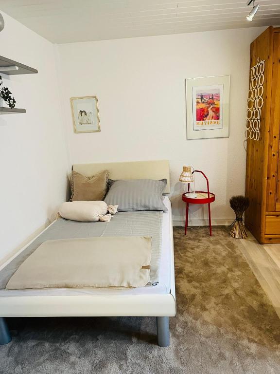a bedroom with a white bed in a room at Ferienwohnung am Weinberg in Flonheim