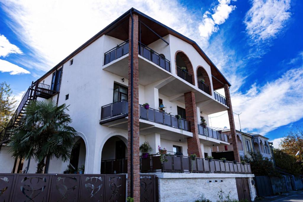 a large white building with balconies on it at Hotel Horizont Telavi in Telavi