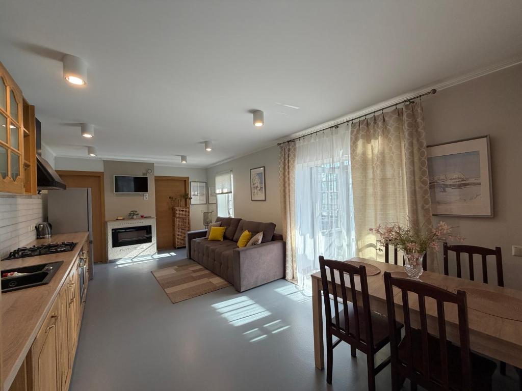 a kitchen and living room with a couch and a table at Mazais Namiņš in Jelgava
