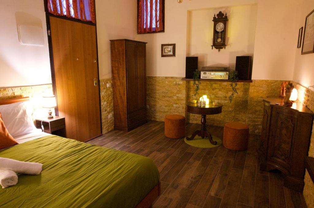 a bedroom with a bed and a clock on the wall at Casa Vacanze Dolce Angelo in Sutri