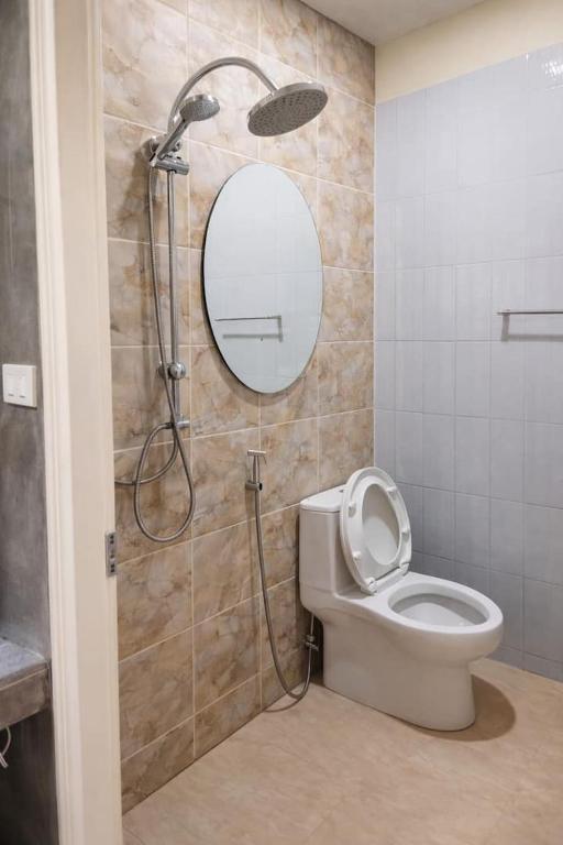 a bathroom with a shower with a toilet and a mirror at อ่าวนางอิงผารีสอร์ท Aingpha resort in Ao Nang 