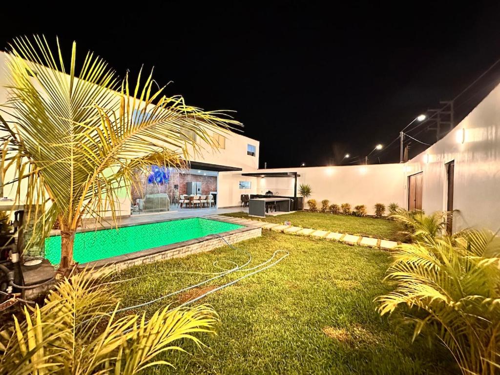 a backyard with a swimming pool at night at Modern house with pool in Ica in Ica