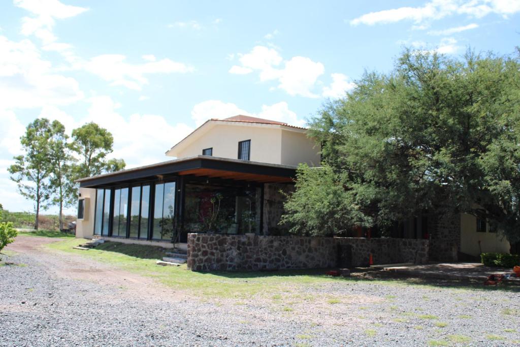 a house with glass windows and a driveway at Casa Ancestra in Santa Cruz