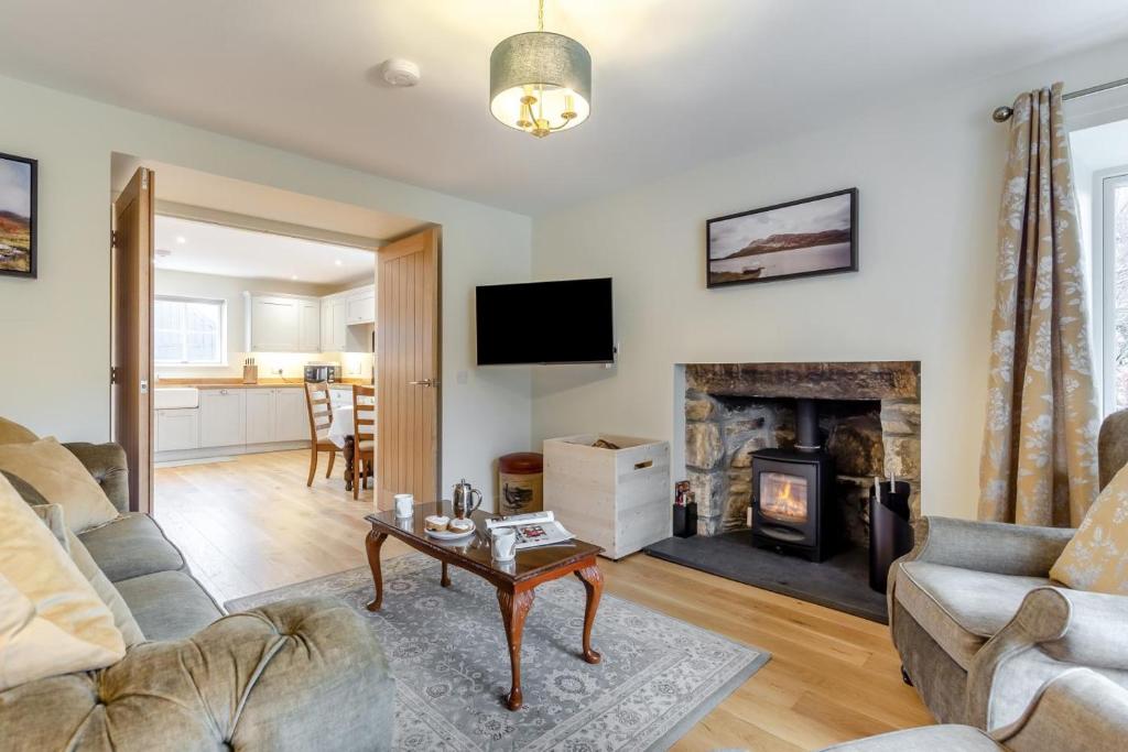 a living room with a couch and a fireplace at 3 Bed in Lairg oc-96459 in Achfary