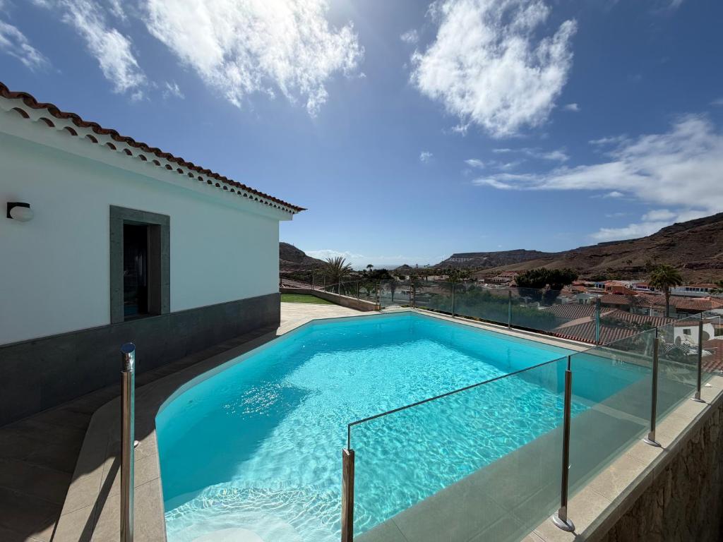 a swimming pool in the backyard of a house at Villa Sunset Tauro in Mogán