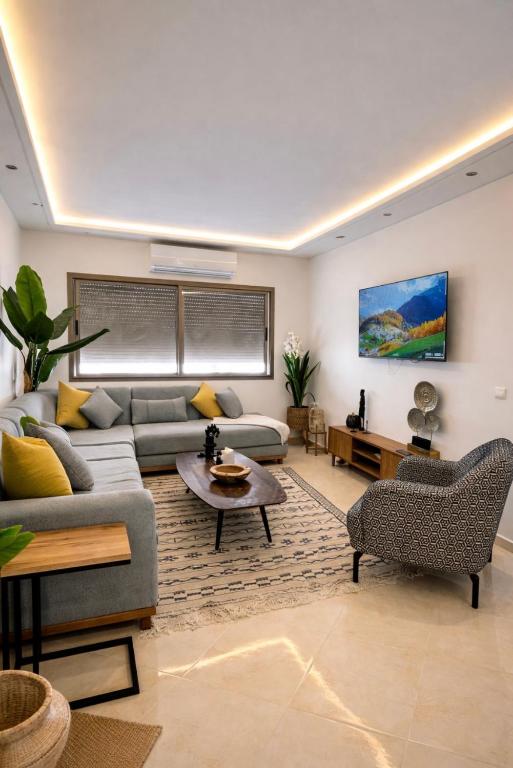 a living room with a couch and a table at Stunning Modern Apartment in heart of Agadir for families in Agadir