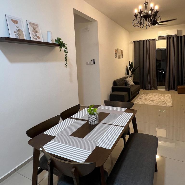 a dining room table and chairs in a living room at Cloud9 Homestay D Aman Residence in Alor Setar