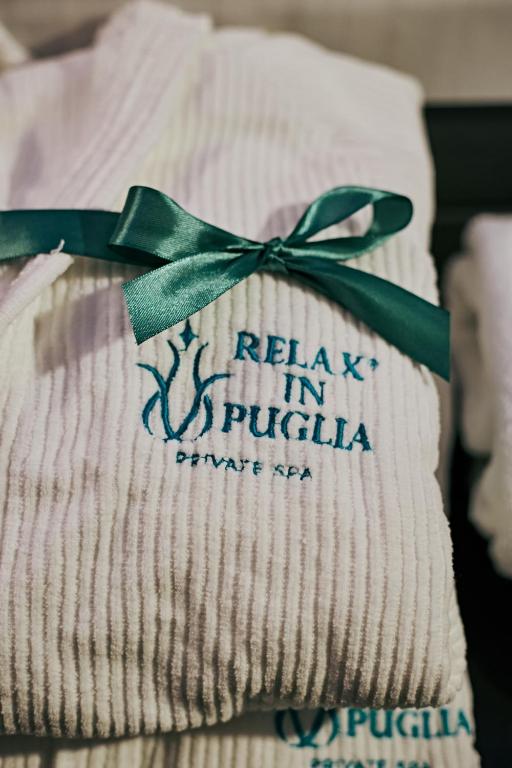 a napkin with a green ribbon on top of it at Relax in Puglia in Corato