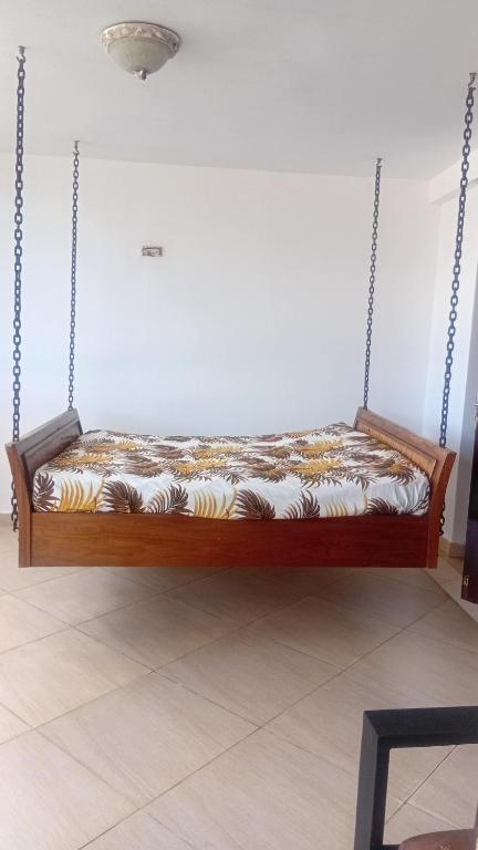 a swing bed in a room at Palm breeze seafront shanzu in Shanzu