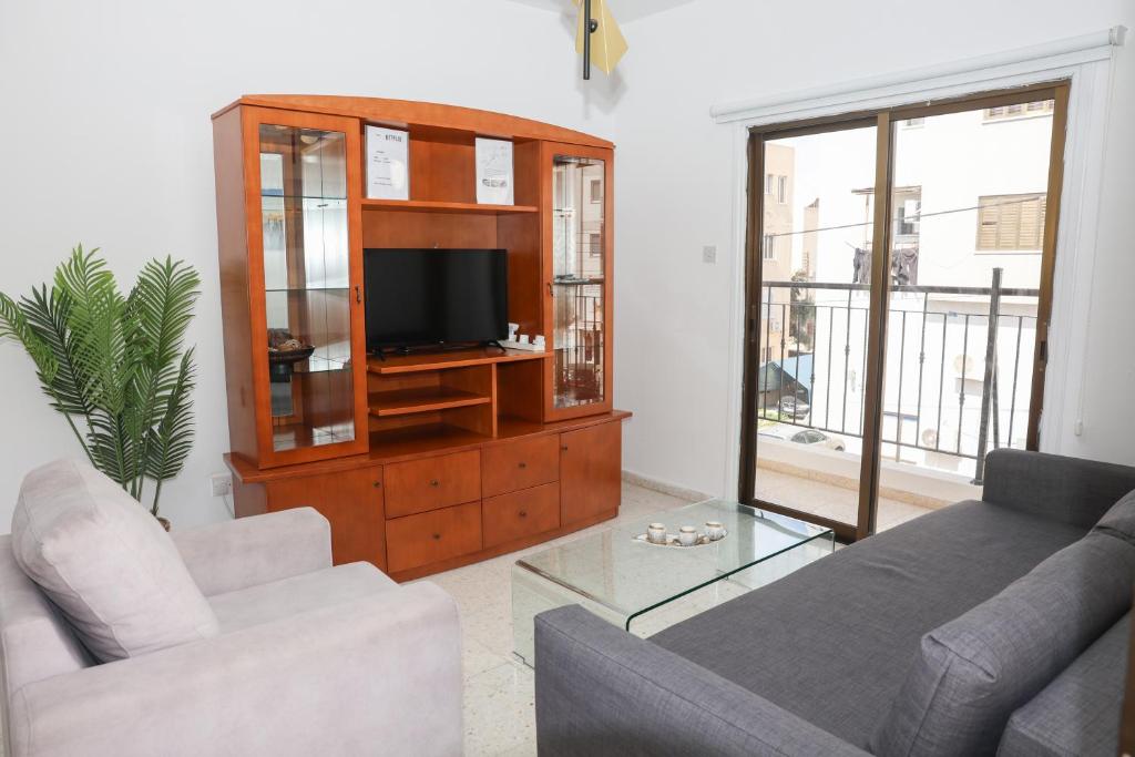 a living room with two couches and a television at Spacious 2 BR appartment near mall -Internet 1Gbps in Paphos