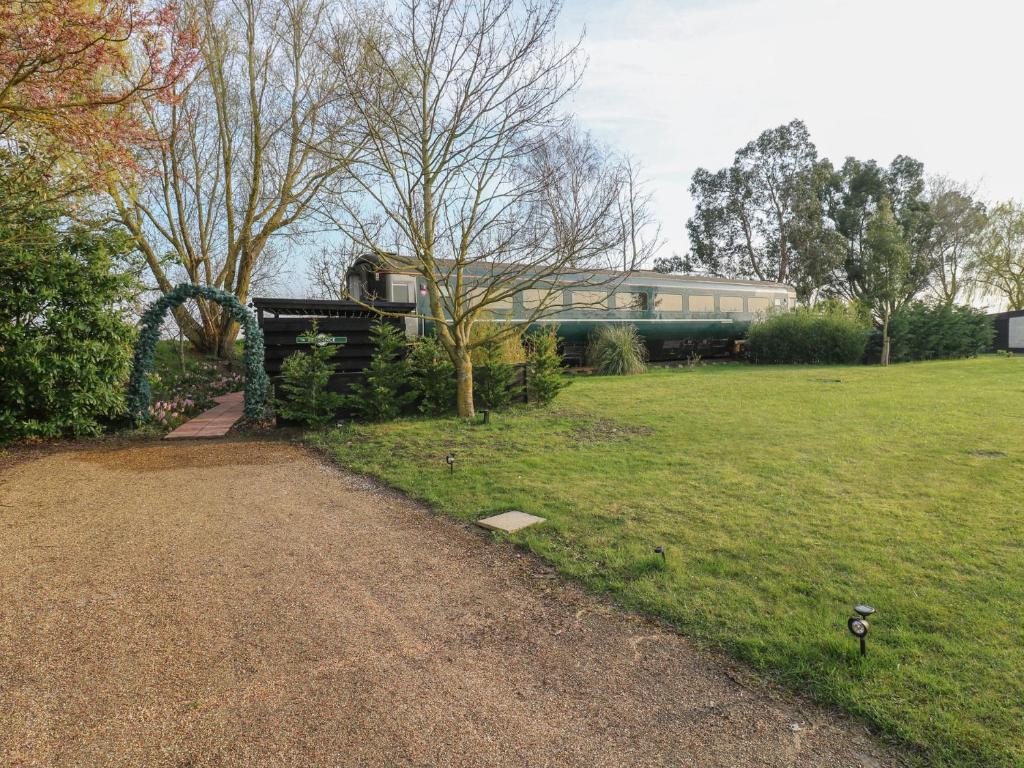 a train traveling through a park with a grass field at The Carriage Ely Penzance in Ely
