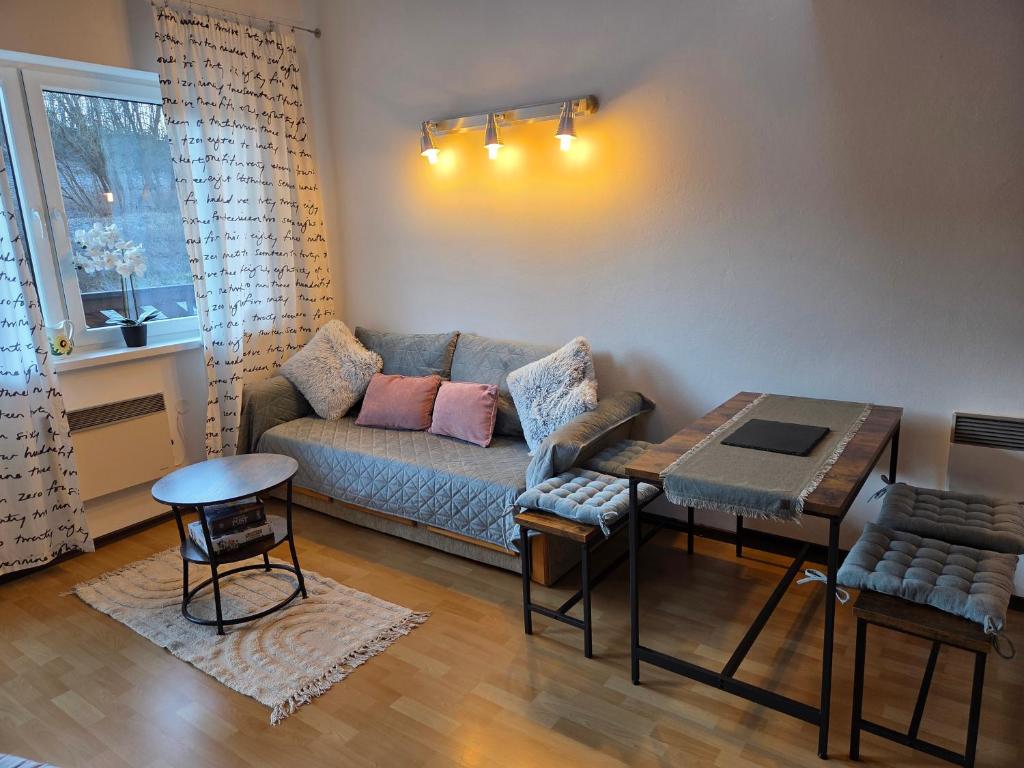 a living room with a couch and a table at Pod strechou Kysúc in Oščadnica