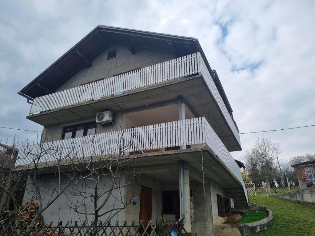 a house with a balcony on top of it at Kuća za zabavu ili odmor-Pegas in Orehovica
