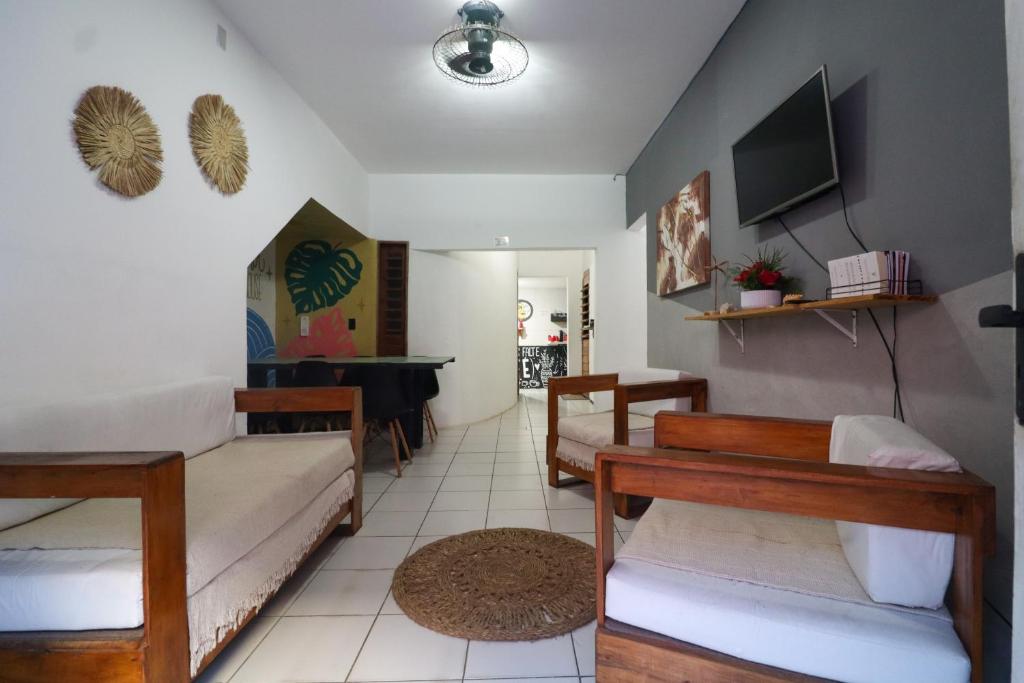 a living room with a couch and a table at Aloha Guest House in Fortaleza