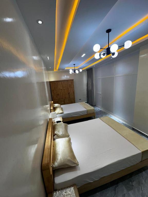 a room with two beds in it with at Résidence Madior F2 in Dakar