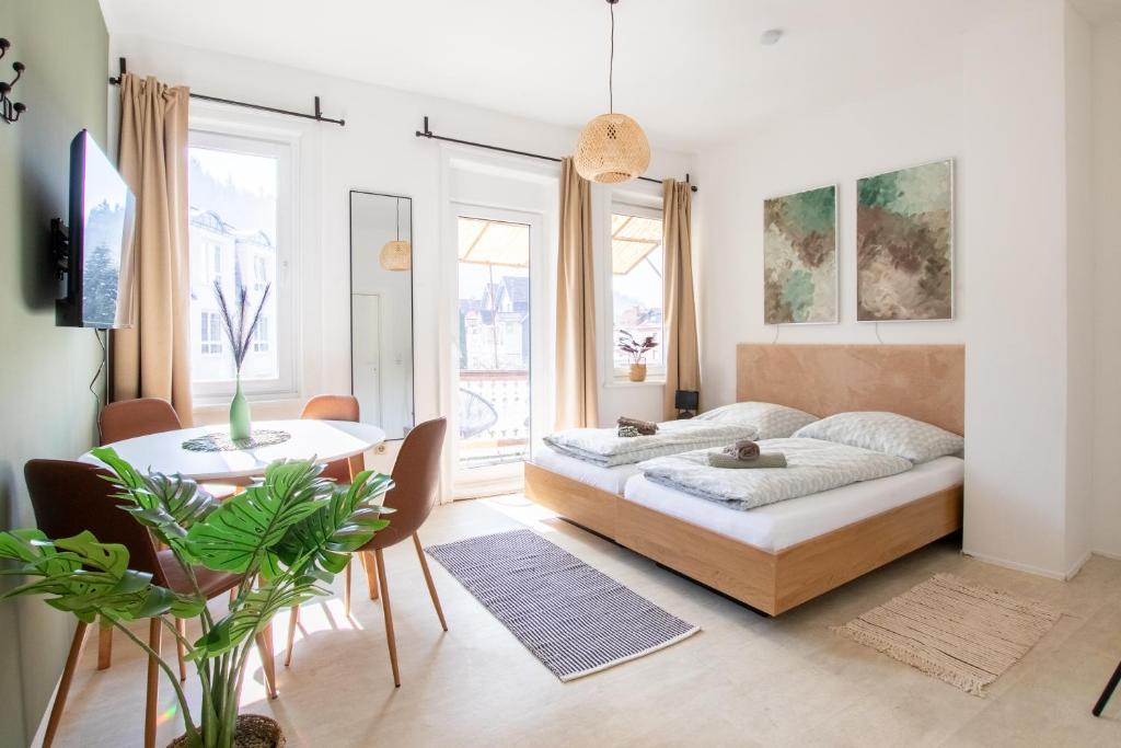 a living room with a bed and a table at Bergsonnen-Stuben in Bad Lauterberg