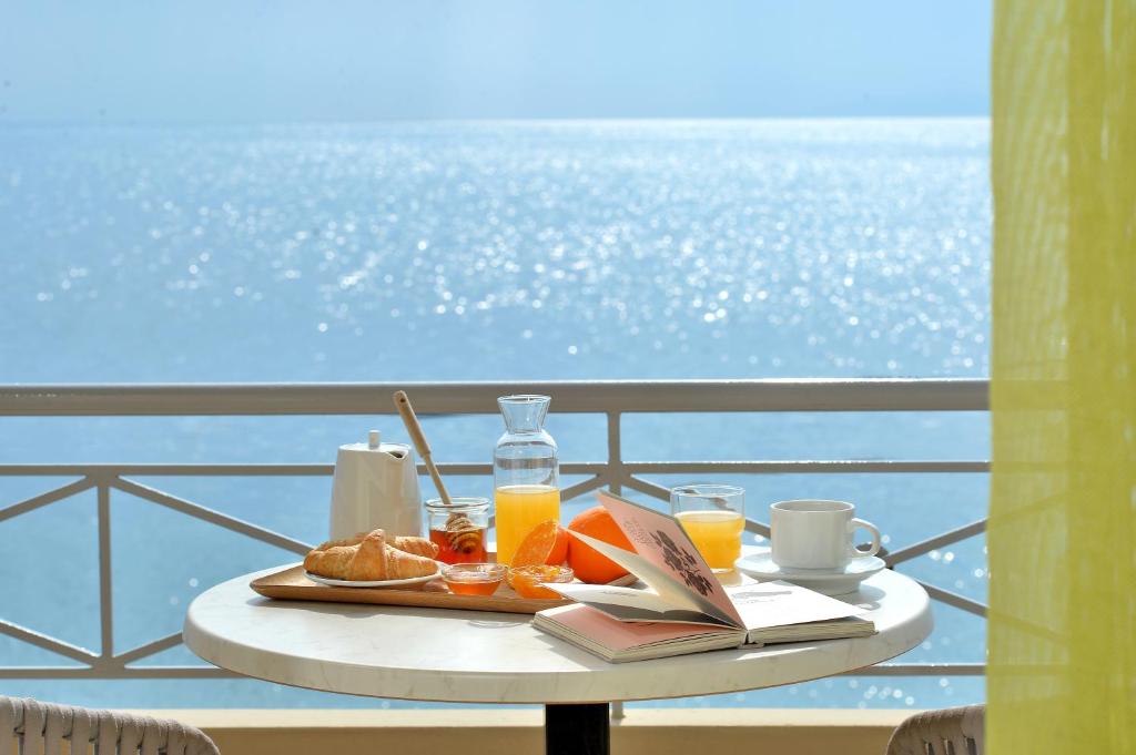 a table with a tray of food and orange juice at Pharos Rooms in Ilia