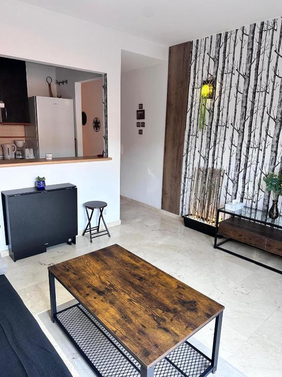 a living room with a wooden table and a tv at playa ancha in San Luis de Sabinillas