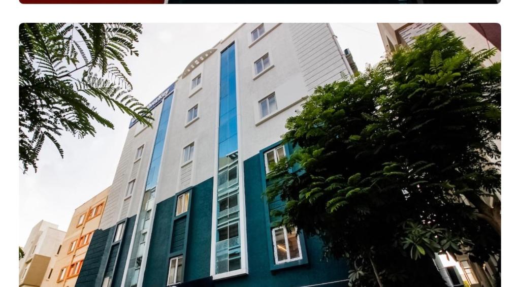 an apartment building with blue and white windows at Hotel Silverkey luxury Rooms in Hyderabad
