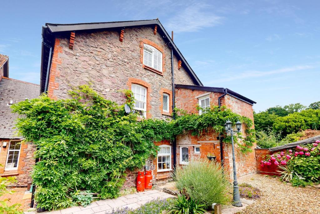 an old brick house with ivy on it at Bowness Porlock in Porlock