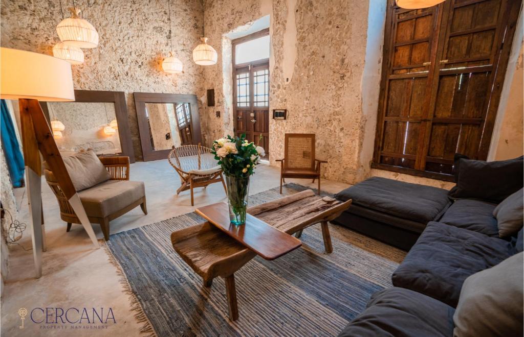 a living room with a vase of flowers on a table at Casa Mandarina 4BDR by Cercana in Mérida
