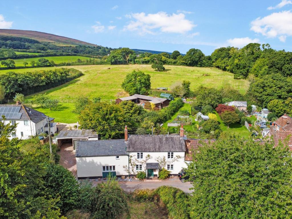 an aerial view of a village with houses and trees at Forge Cottage Wootton Courtenay in Minehead