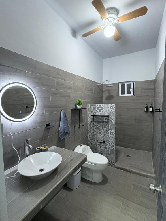 a bathroom with a white sink and a toilet at Los Agaves Lto in Loreto