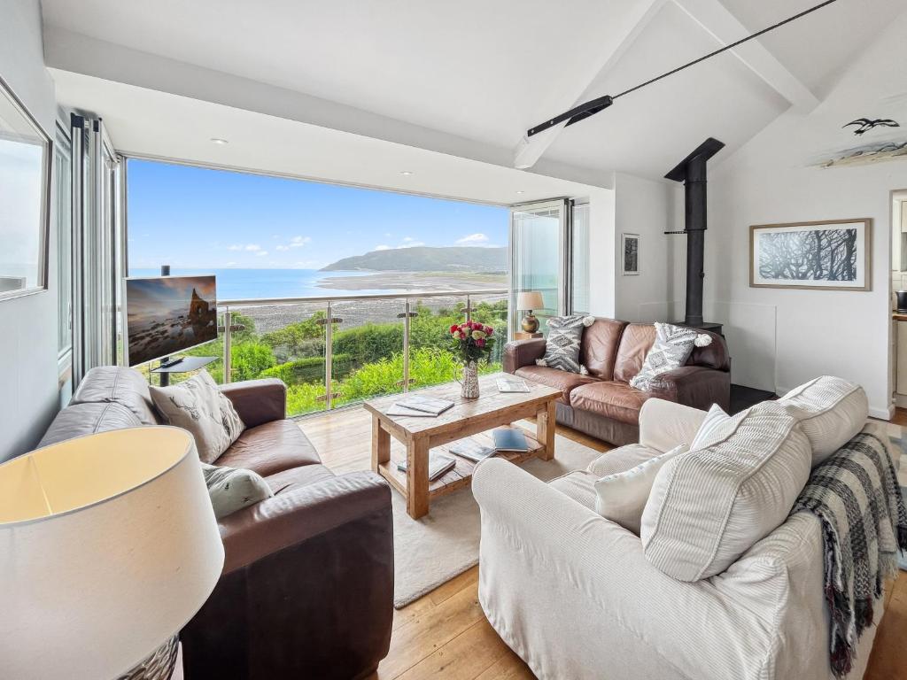 a living room with a view of the ocean at St Anthonys Cottage Porlock Weir in Porlock