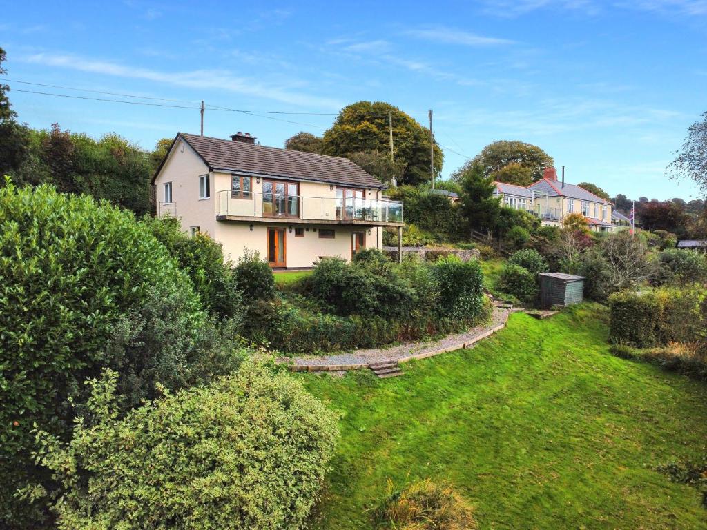 a house on a hill with a yard at Ormrods Withypool in Withypool