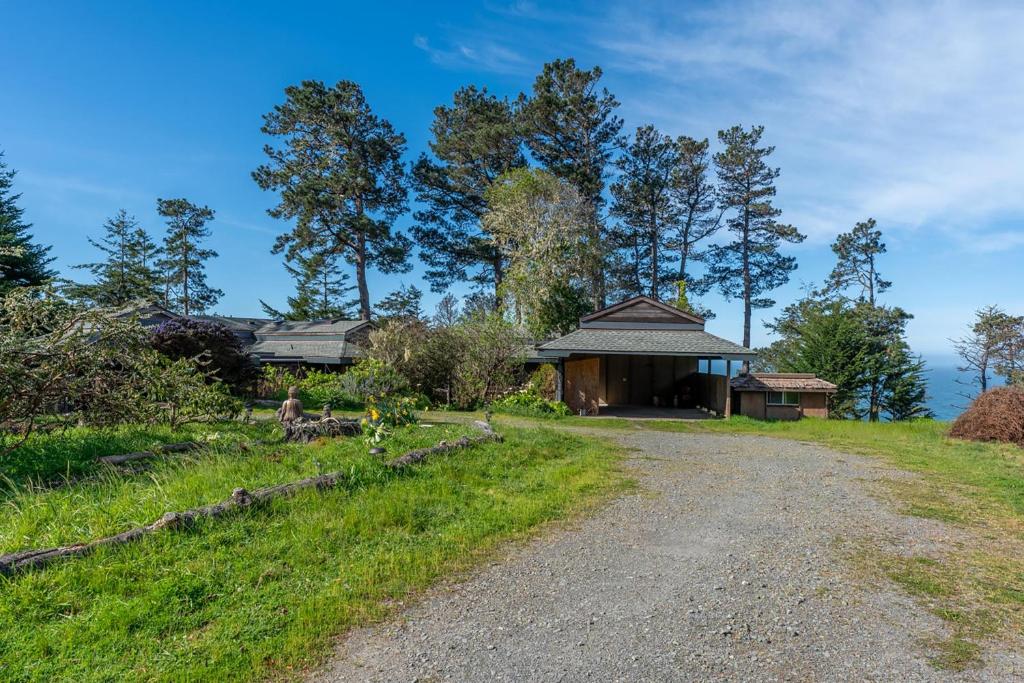 a house on a hill with a gravel road at Lighthouse in Little River