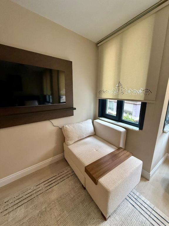 a living room with a couch and a window at MEYS Apartment 2 in Istanbul