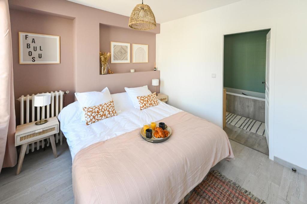 a bedroom with a bed with a bowl of fruit on it at La Belle Droite in Le Havre