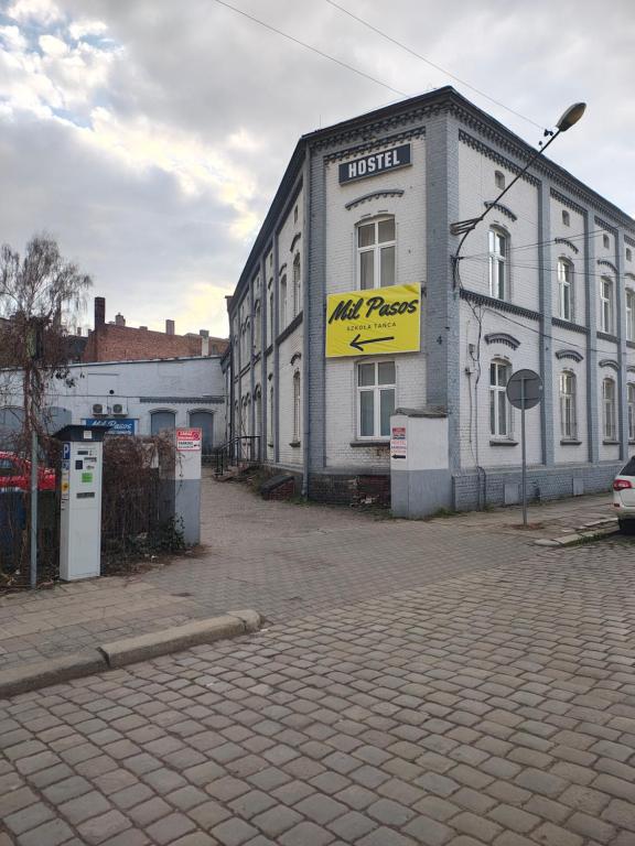 a building with a sign on the side of it at Hostel Kamienna Centrum in Katowice