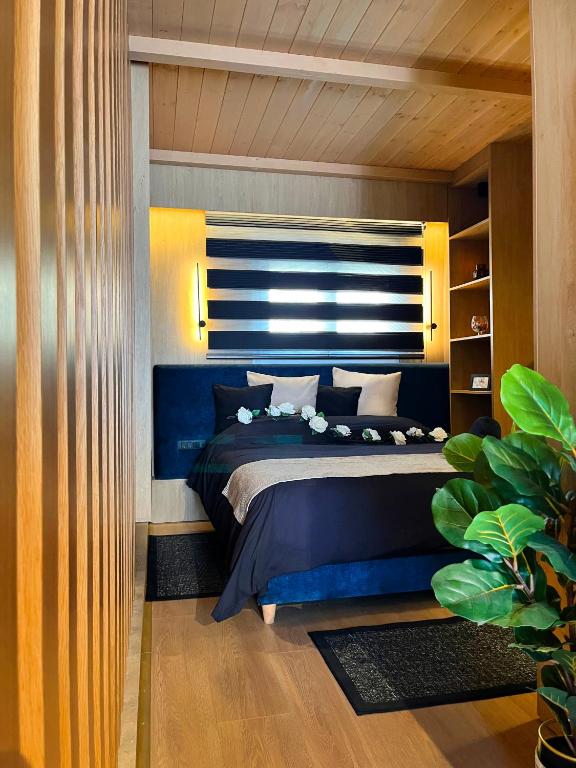 a bedroom with a bed with a blue comforter at Casa Georgia in Kefalos