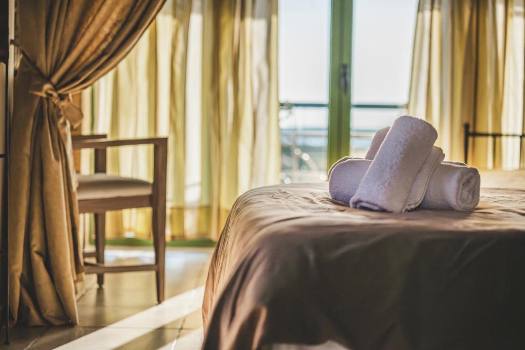 a hotel room with a bed with a towel on it at GAIA - Boutique Retreat in Marathopoli