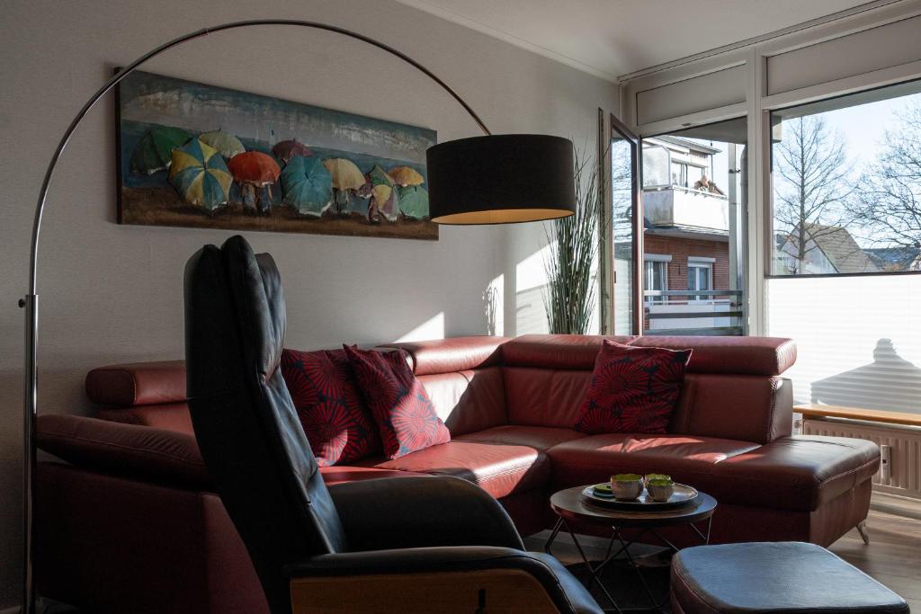 a living room with a couch and a table at Apartment Enjoy in Büsum