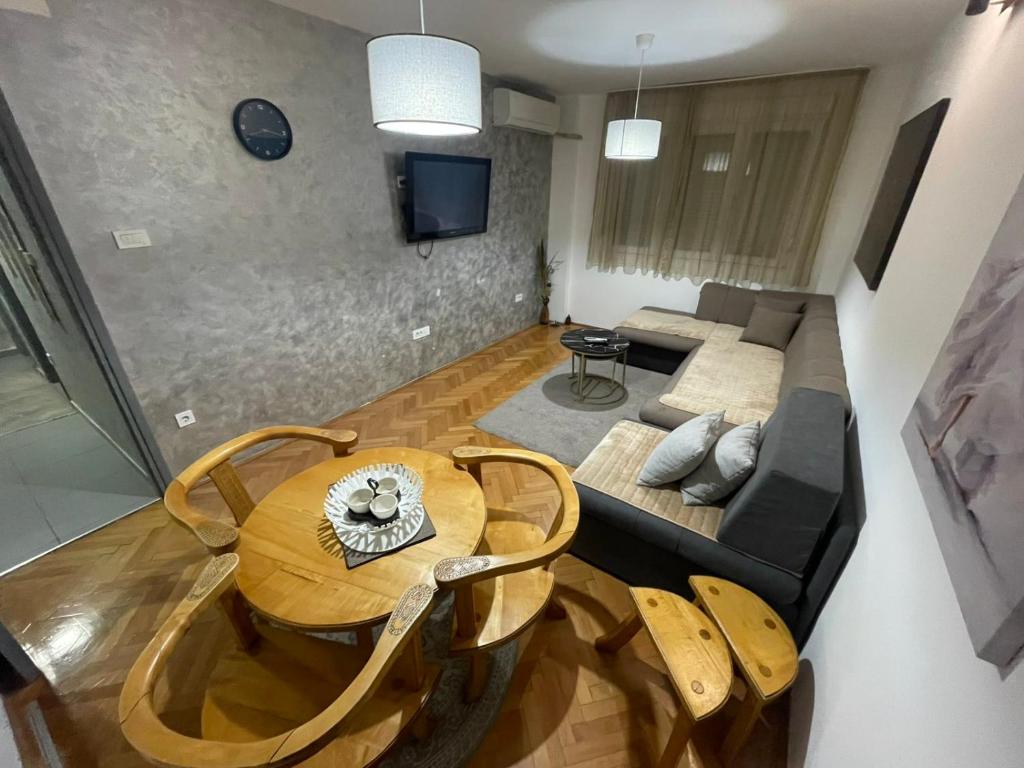 a living room with a table and a couch at Apartments Ciki in Podgorica