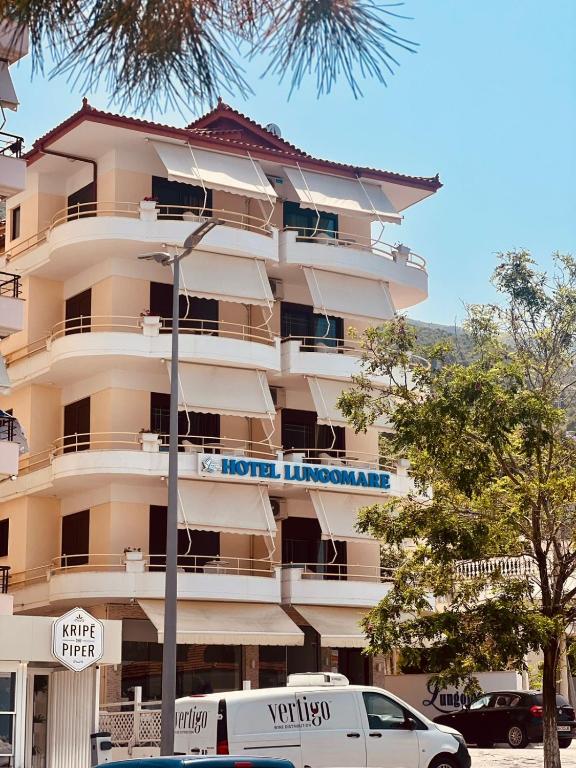 a building with a street sign in front of it at Hotel Lungomare in Vlorë