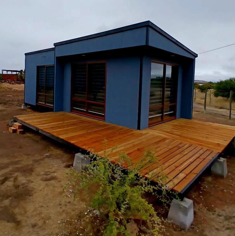 a blue house with a wooden deck at Tiny House Sublime in Trinidad