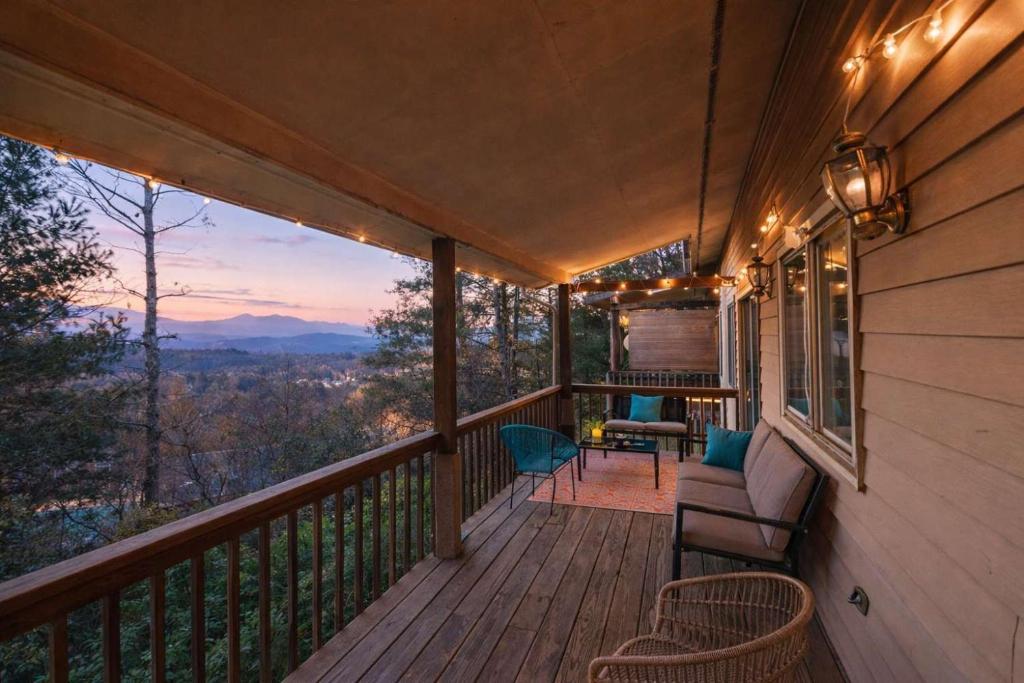 a porch with chairs and a table and a view at The Sanctuary Company Johnson City in Johnson City