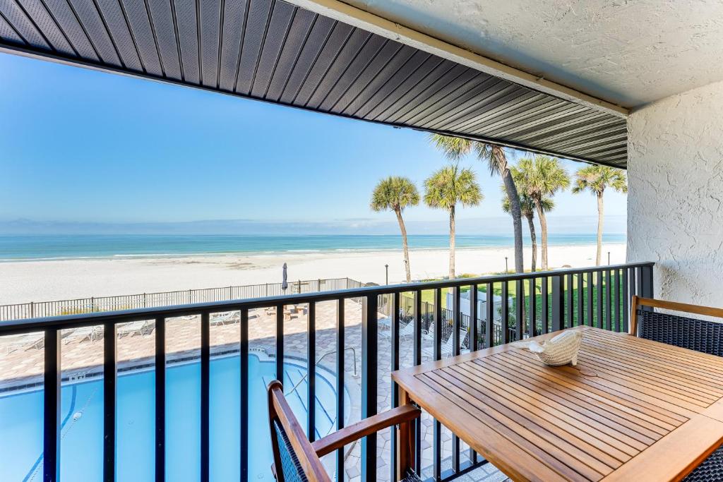 a balcony with a table and a view of the beach at Beachfront! Indian Rocks Beach Condo w/ Balcony in Clearwater Beach