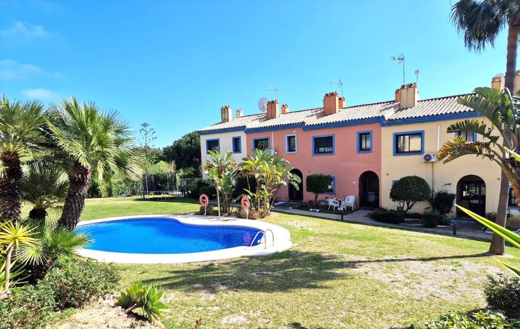 a house with a swimming pool in front of a yard at Casa Tranquila La Duquesa in Manilva