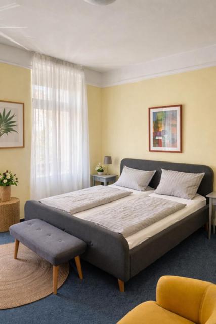 a bedroom with a large bed and a window at Gästehaus Bock in Lahnstein