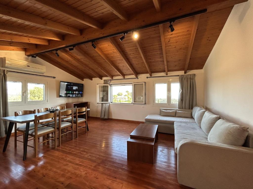 a living room with a couch and a table at Stavroula's House in Argyrádes