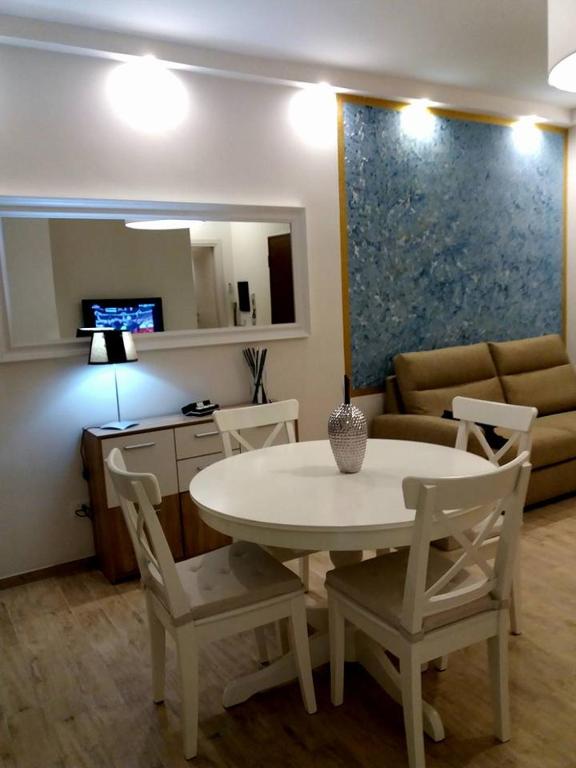 a living room with a table and chairs and a couch at Flat via Irlanda 26 in Quartu Sant'Elena