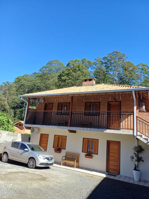 a house with a car parked in front of it at Refugio Victoria in Monte Verde