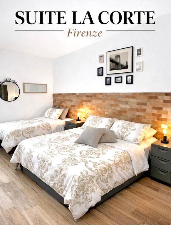 a bedroom with two beds and a sign that reads suite la core fire at Suite La Corte in Florence