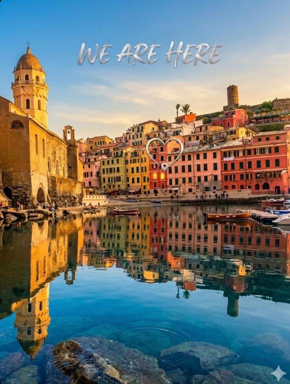a city reflecting in the water with the words we are here at Silver Flat in Vernazza