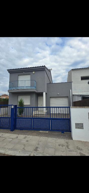 a large house with a blue fence in front of it at Mediterraneo in Peniscola