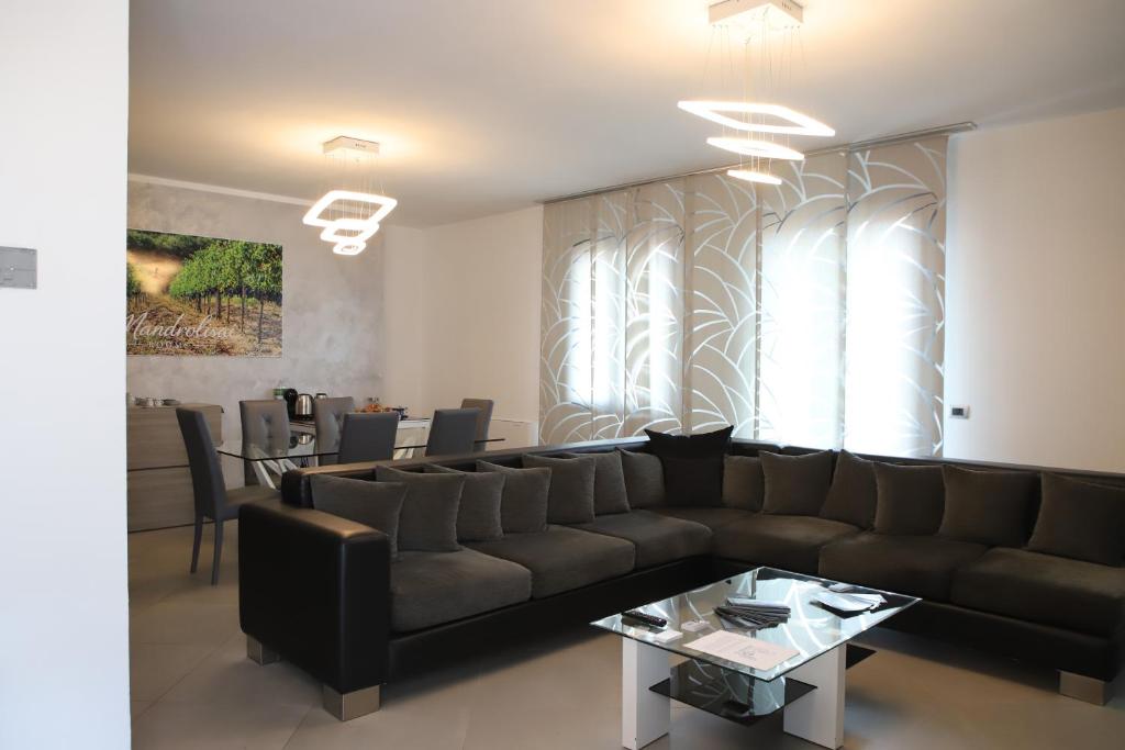 a living room with a couch and a table at Mandrolisai Rooms in Samughèo